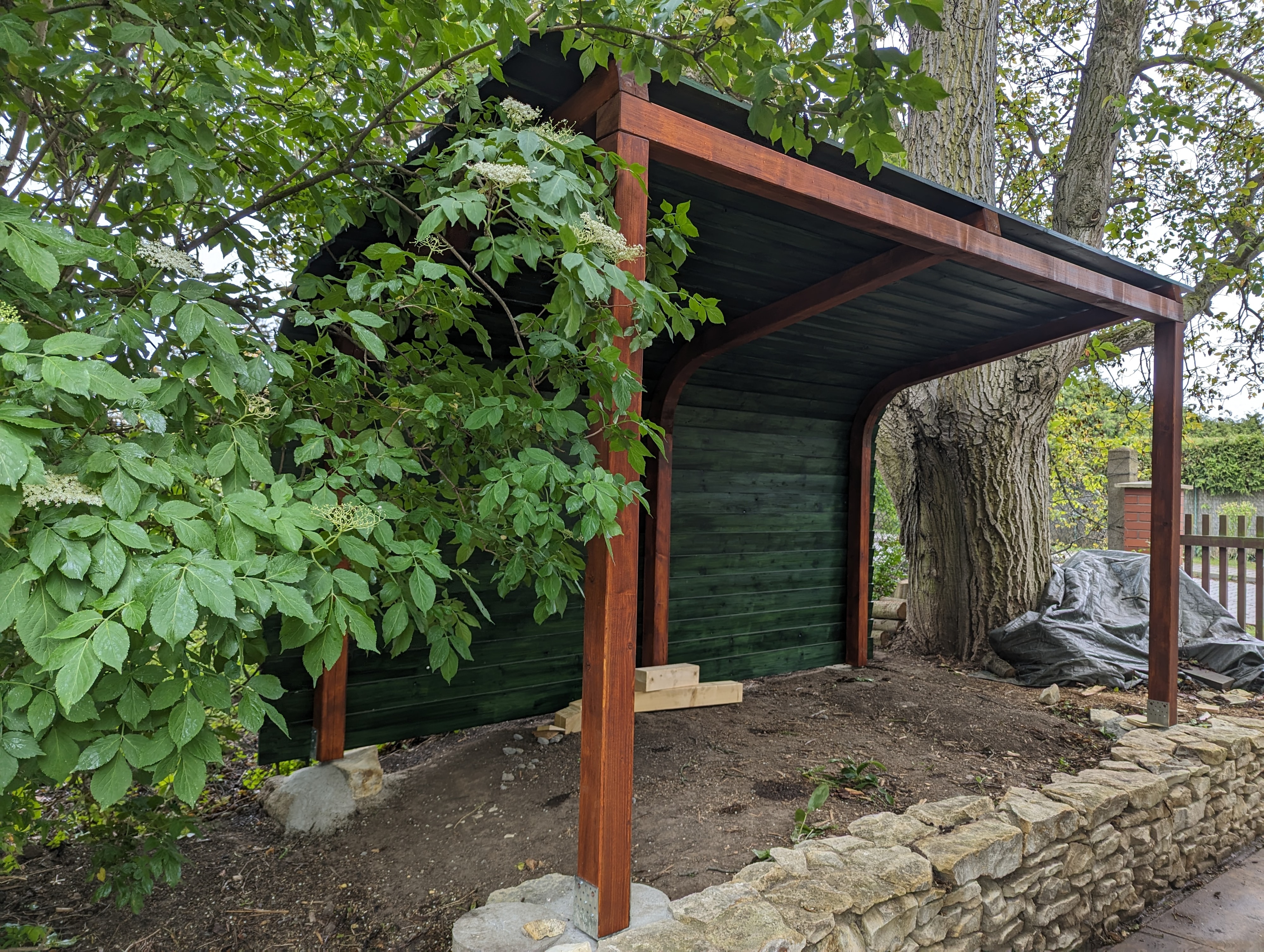 Woodgon — detail of woodshed timber frame and firewood storage