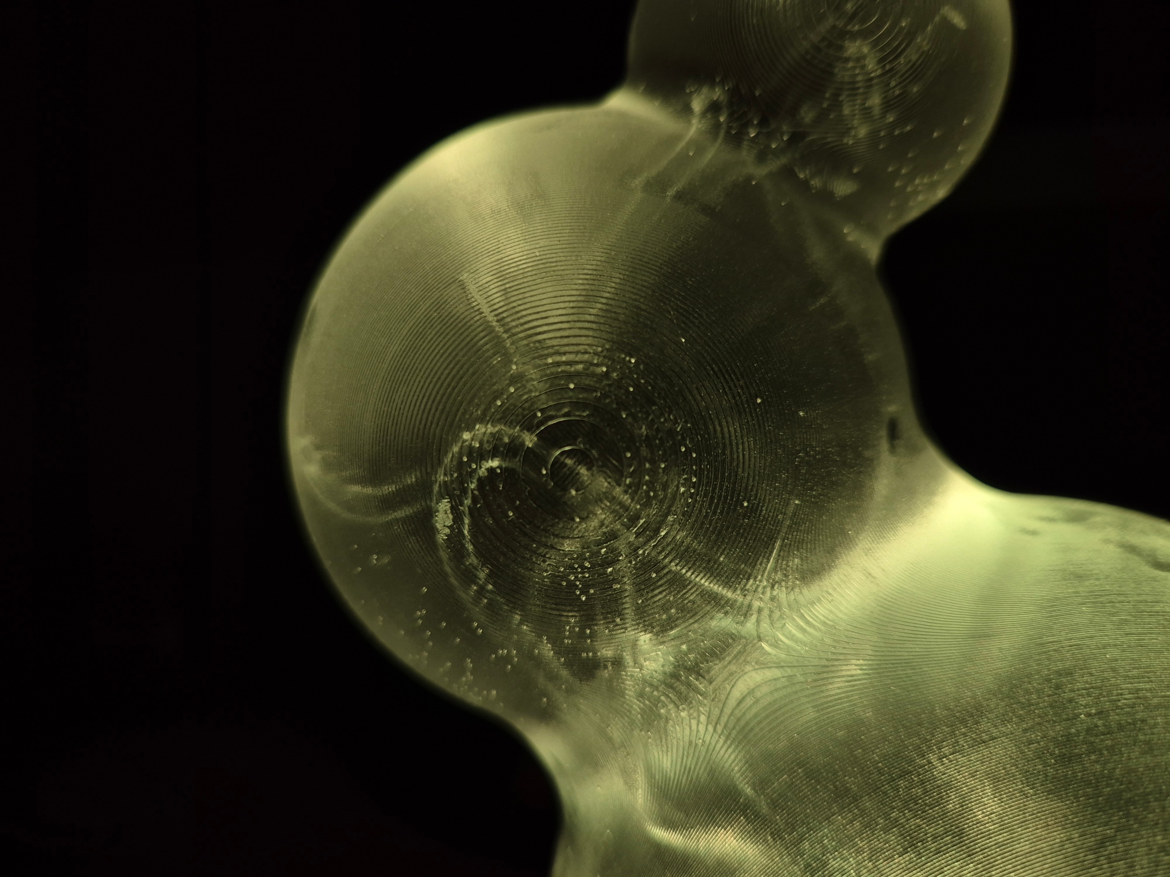 Iskanin — macro of translucent 3D-printed sphere with concentric layer lines